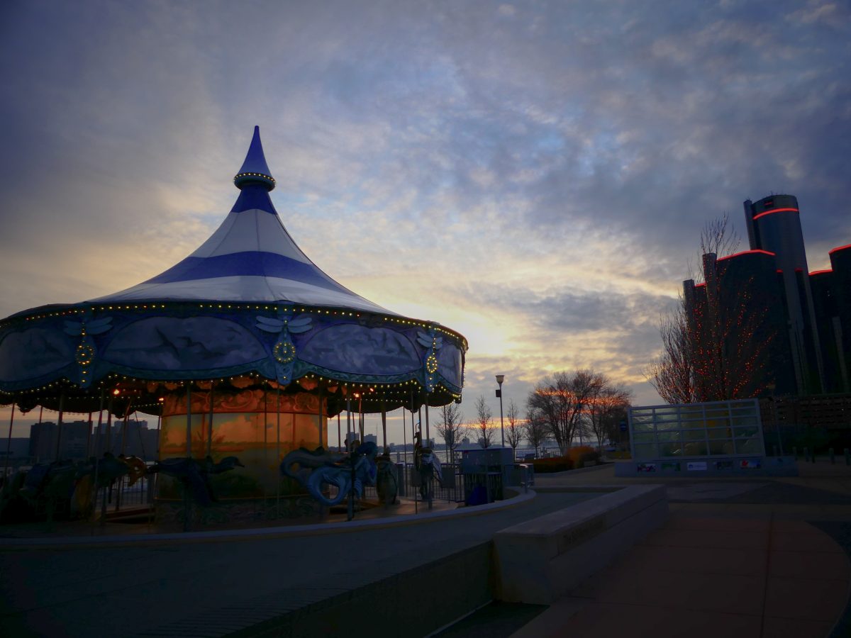 Impassive - There is a recording of the artist describing the image below. This picture angled towards the renaissance center with a carousel on the side has an eerie darkness creeping into it to portray the city overall as scary and dangerous. The purpose was to let the viewers see how the media negatively portrays Detroit.